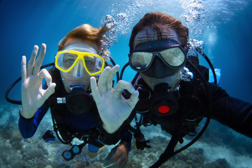 Two divers giving the super gesture while using Gator Gill LLC springs diving equipment during a Florida freshwater dive